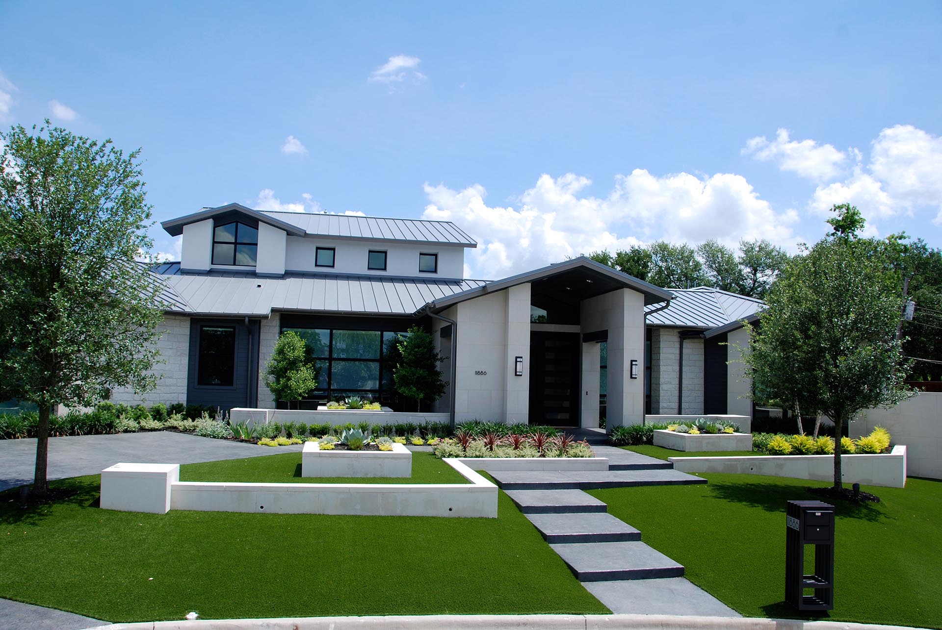 Contemporary modern garden with metal planters in Dallas by landscape designer