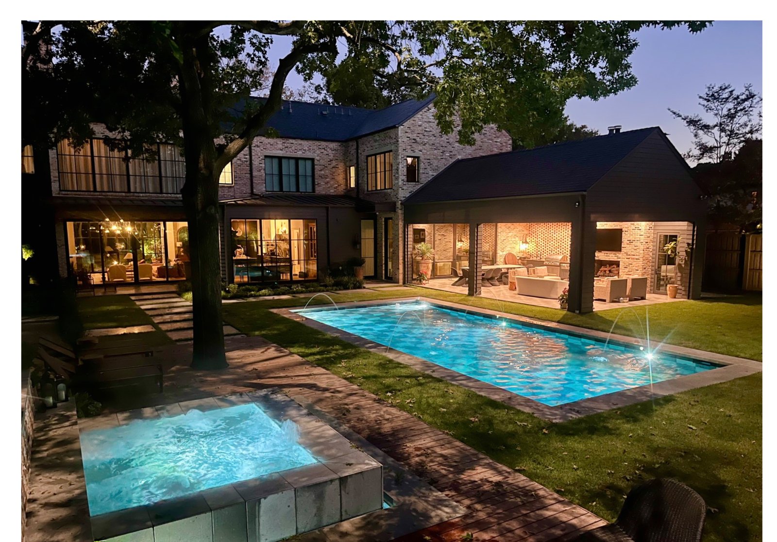 Transitional Modern pool, spa, and home at dusk - luxury landscape design by Original Landscape Concepts in Lakewood, Dallas